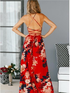 Detail of bohemian red floral maxi dress showing the backless cross-strap design