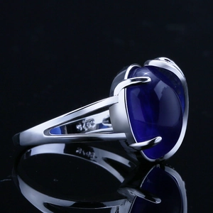 Macro view of S925 sterling silver ring featuring a large blue oval sapphire stone