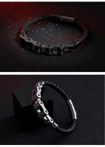 Detail view of a black leather motorcycle chain bracelet with magnetic clasp on a red light background