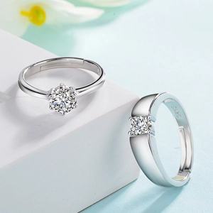 Adjustable S925 silver couple rings set with round-cut cubic zirconia in blue background