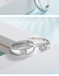 Macro shot of S925 sterling silver couple rings with cubic zirconia in six-prong setting