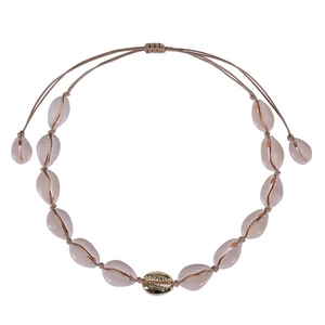 Detailed macro view of woven shell necklace with central golden shell and adjustable knot