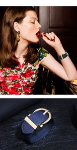 Detail view of wide faux leather bracelets in black and navy with gold metal buckles