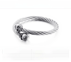 Macro detail of skull-head twisted cable wire cuff bracelet made of 316L stainless steel