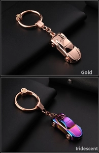 Detailed view of polished zinc alloy car model keychains in gold and iridescent finishes