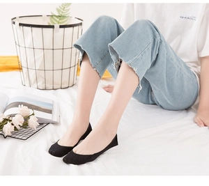 Detail of black cotton invisible boat socks worn with casual denim for daily comfort