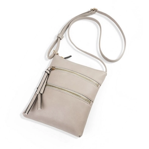 Detailed view of grey leather crossbody phone bag with triple zippers and tassel charm