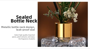 Detail of elegant bubble glass diffuser bottle with golden cap and white dried flowers