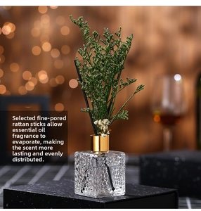 Macro detail of reed diffuser with purple dried flowers and textured glass bottle