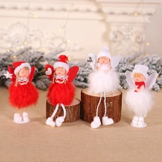 Detailed view of four festive wooden Christmas angel dolls in red and white feather skirts