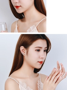 Detail of silver long star ear climbers with sparkling rhinestones on model's ear