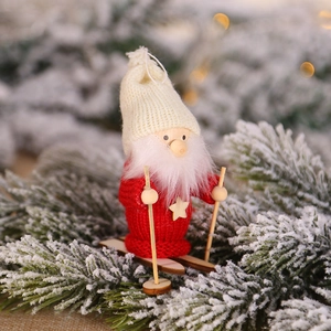 Charming wooden skiing Santa ornament with red knit sweater and mini skis for Christmas tree