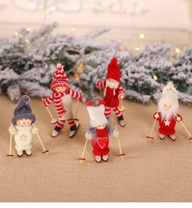 Close-up of five knitted Christmas ski dolls with wooden sticks and plush textures