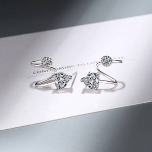 Sparkling silver heart-shaped stud earrings with round zircon stones in a polished setting