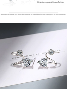 Detail view of silver S-shaped heart earrings with sparkling cubic zirconia crystals