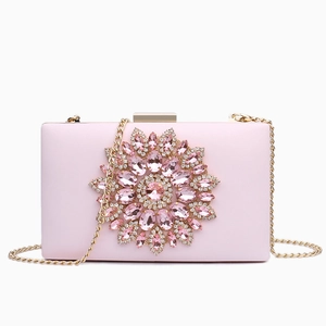 Pink evening clutch bag featuring crystal flower design and detachable gold chain strap