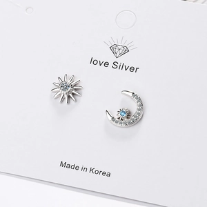 Asymmetric silver star and moon stud earrings with sparkling crystals for women