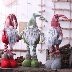 Three Christmas telescopic gnomes with striped hats and long legs on rustic wood background