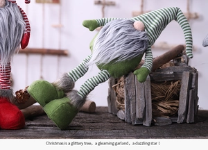 Detail of Christmas gnomes with striped knit hats and long faux fur beards on wood