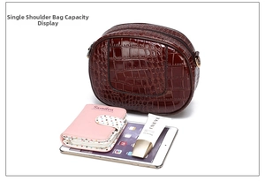 Detail view of mini crocodile pattern backpack showing interior capacity with tablet and wallet