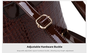Detail of adjustable shoulder strap in dark brown crocodile embossed patent leather