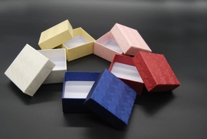 Macro view of assorted jewelry gift boxes with scallop embossed textures in multiple colors