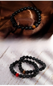 Detail of 8mm beaded bracelets featuring lava stone, matte onyx, and tiger eye gems