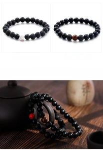 Detail view of 8mm lava rock and matte onyx beaded bracelets in a zen tea ceremony setting