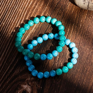 Retro turquoise beaded bracelet set with natural vein texture on dark wood background