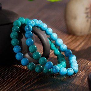 Retro turquoise beaded bracelets for men and women on a rustic ceramic teapot