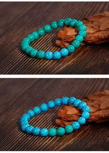 Macro detail of turquoise beaded bracelet with marble texture on vintage wood background