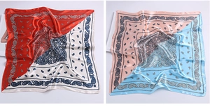 Detailed close-up of paisley pattern satin square scarves in red-white and pink-blue colors