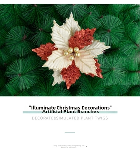 Detail of glittered red and cream Christmas flower with gold berries and pine needles