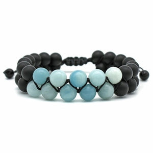 Macro detail of double-layer braided bracelet with lava rock and tiger eye stone beads