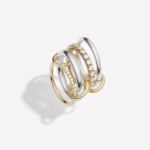 Macro detail of interlocked three-band ring with gold, silver and pave-set stones