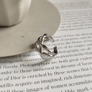 Minimalist 925 sterling silver multi-layer woven open ring on aesthetic white plate