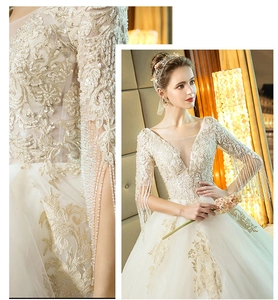 Exquisite close-up of ivory wedding dress featuring fringe beaded sleeves and lace embroidery