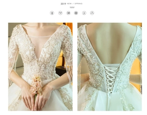Close-up of elegant V-neck bridal gown featuring silver embroidery and beaded tassels