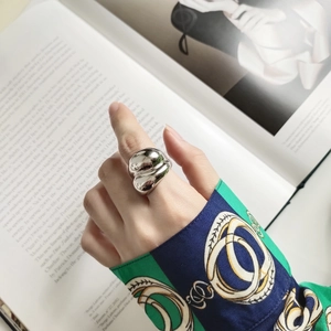 Artistic irregular fluid 925 silver ring with a polished mirror finish on model hand