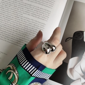 Chunky 925 sterling silver minimalist ring worn by a model against a fashion magazine