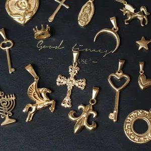 Collection of polished gold-plated charms including pegasus and moon on black leather