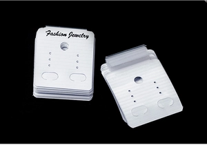 Macro shot of white Fashion Jewelry PVC display cards for earrings on black background