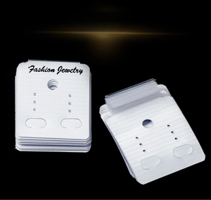Detail view of white PVC jewelry display cards for earrings and necklaces on black background