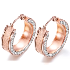 Close-up of 8mm rose gold stainless steel hoop earrings with frosted finish and crystals