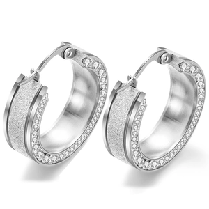 Detailed view of silver hoop earrings featuring frosted finish and sparkling zircon stones