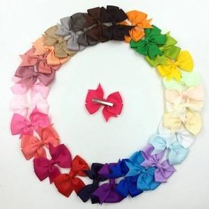 Detailed view of colorful grosgrain ribbon bows with durable metal alligator clips