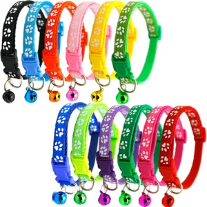 Flat lay of 12 colorful nylon pet collars with heart paw prints and safety bells