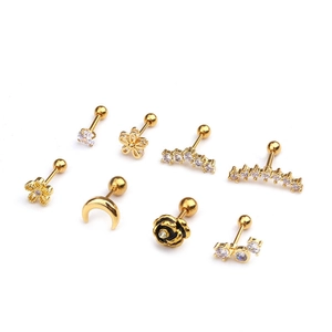 Set of eight golden flower and moon stud earrings featuring clear zircon stones