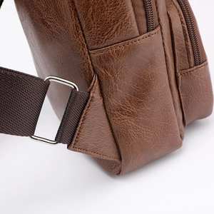 Brown faux leather crossbody bag with fabric strap and metal ring connection detail