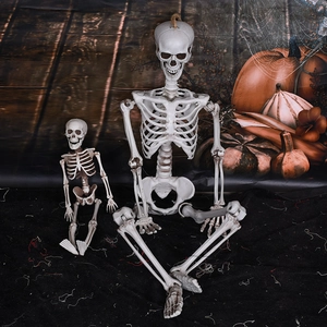 Halloween decorative plastic skeleton models with movable joints in a spooky setting